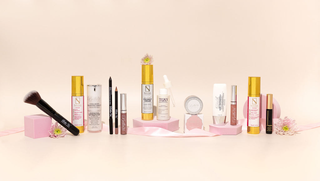 Online Skincare Shop in New Zealand, Multiple Beauty Brand Products Laid Out on Pink Background.